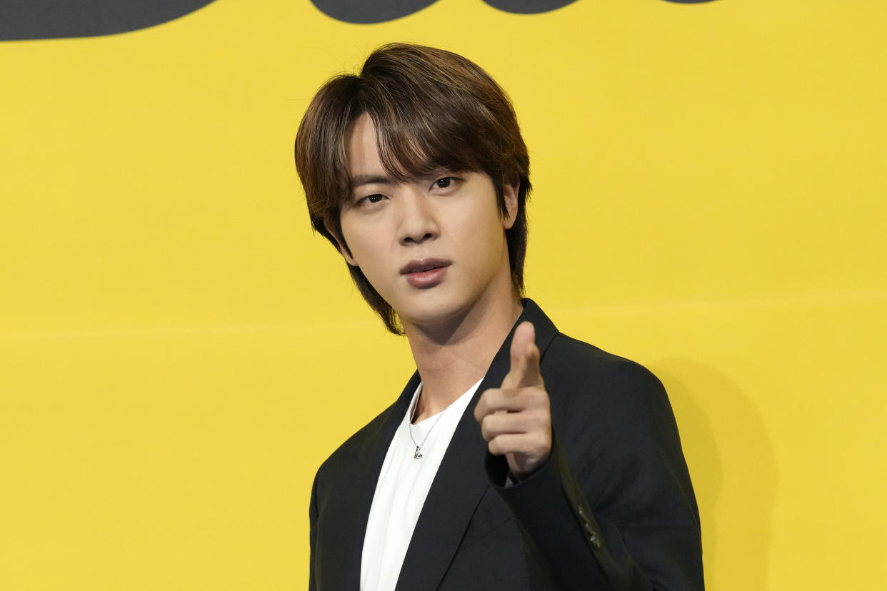 FILE - Jin, a member of South Korean K-pop band BTS poses for photographers ahead of a press conference to introduce their new single 