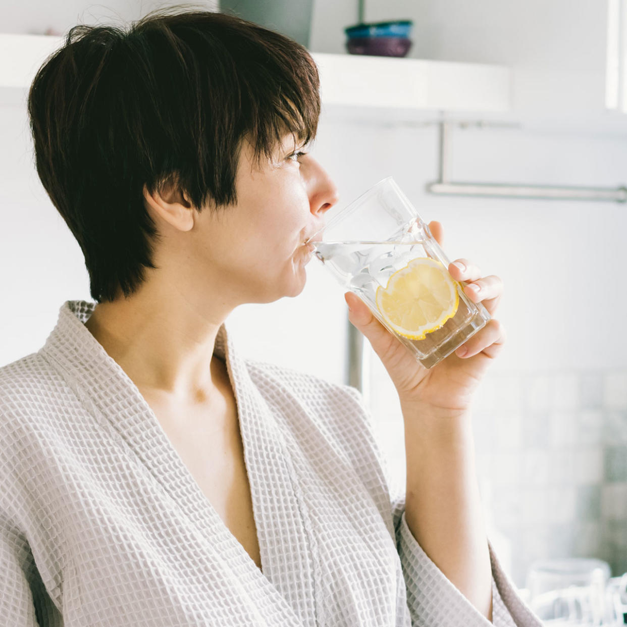 woman drinking lemon water in the morning