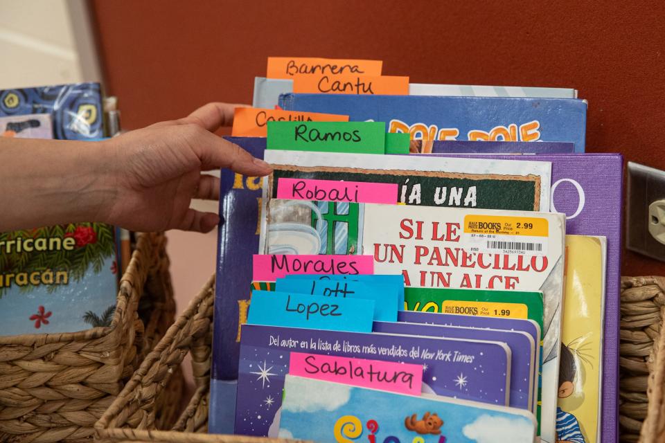 Heather Gonzalez, a special education speech and language pathologist, flips through books to be read to students by guests for Hispanic Heritage Month at Blanche Moore Elementary School on Thursday, Sept. 28, 2023, in Corpus Christi, Texas.