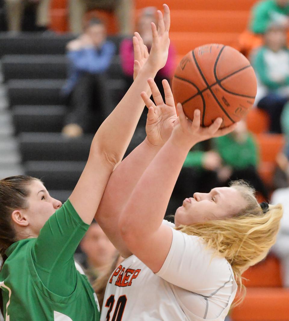 South Fayette High School senior Ava Leroux, left, defends a first-half shot by Cathedral Prep sophomore Addie Biel during a PIAA Class 5A basketball quarterfinal playoff game at Sharon High School.