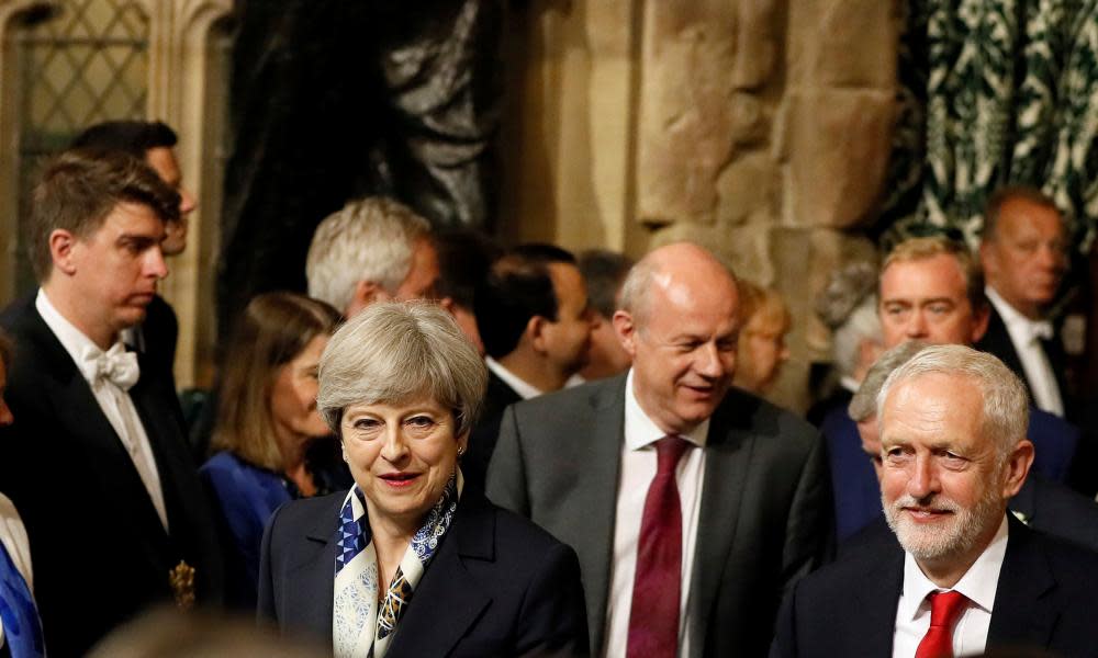 Theresa May and Jeremy Corbyn, walk through the Peers Lobby in the Houses of Parliament during the State Opening of Parliament