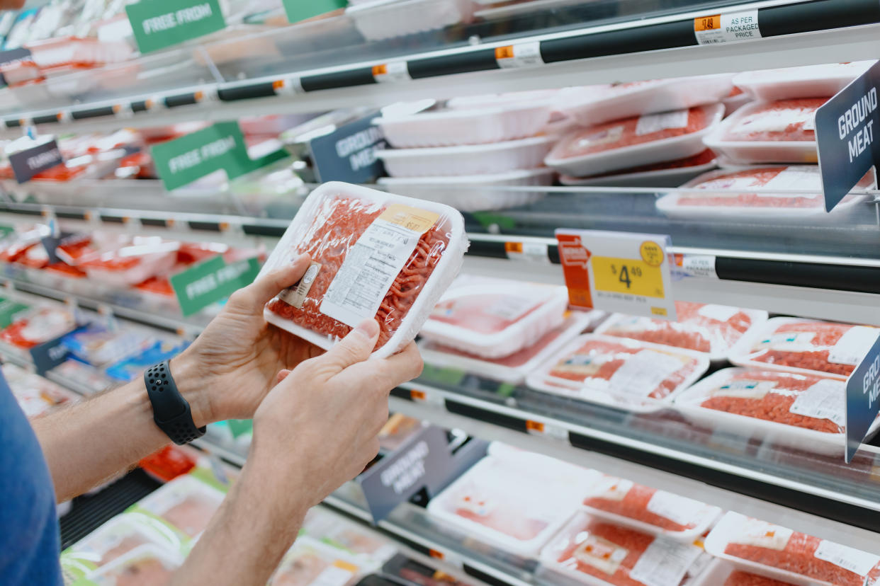 Close-up of unrecognizable white man checking the price of ground beef at supermarket