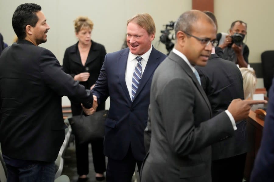 <em>Jon Gruden, center, appears in court Wednesday, May 25, 2022, in Las Vegas. A Nevada judge heard a bid Wednesday by the National Football League to dismiss former Las Vegas Raiders coach Jon Gruden’s lawsuit accusing the league of a “malicious and orchestrated campaign” including the leaking of offensive emails ahead of his resignation last October. (AP Photo/John Locher)</em>