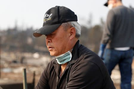 Retiree Kaan Chin looks on as he sorts through the rubble of his home destroyed by the Tubbs Fire in Santa Rosa. REUTERS/Stephen Lam