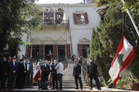 Lebanese Foreign Minister Charbel Wehbe, center right, speaks during a joint press conference with his Iranian counterpart Mohammad Javad Zarif, center left, outside the Lebanese foreign ministry damaged by last week's explosion that his the seaport of Beirut, Lebanon, Friday, Aug. 14, 2020. (AP Photo/Hussein Malla)