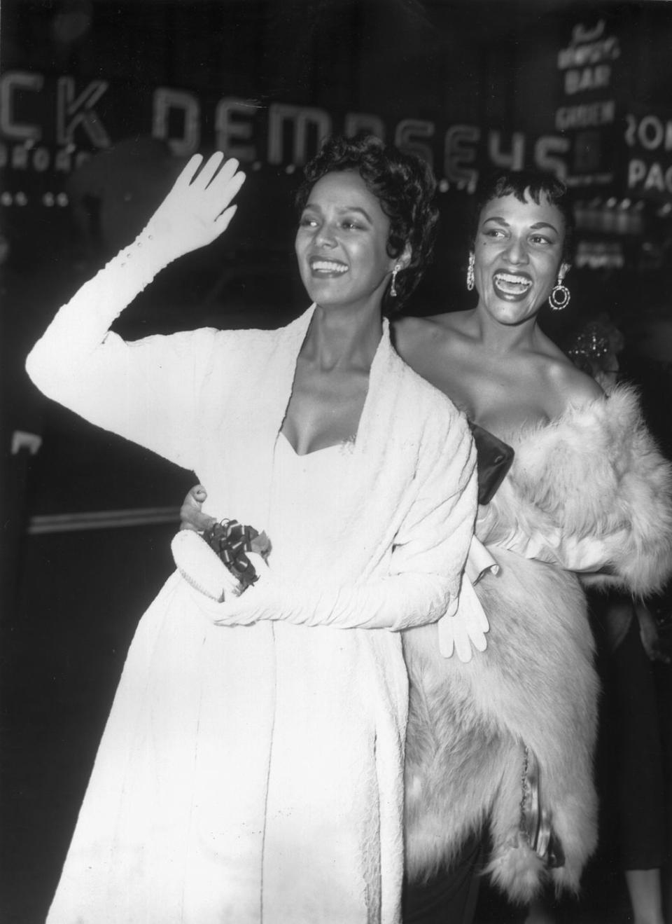 <p>Dorothy Dandridge and her sister, Vivian Dandridge, walking the red carpet in evening gowns, opera gloves, and an opulent fur sole.</p>