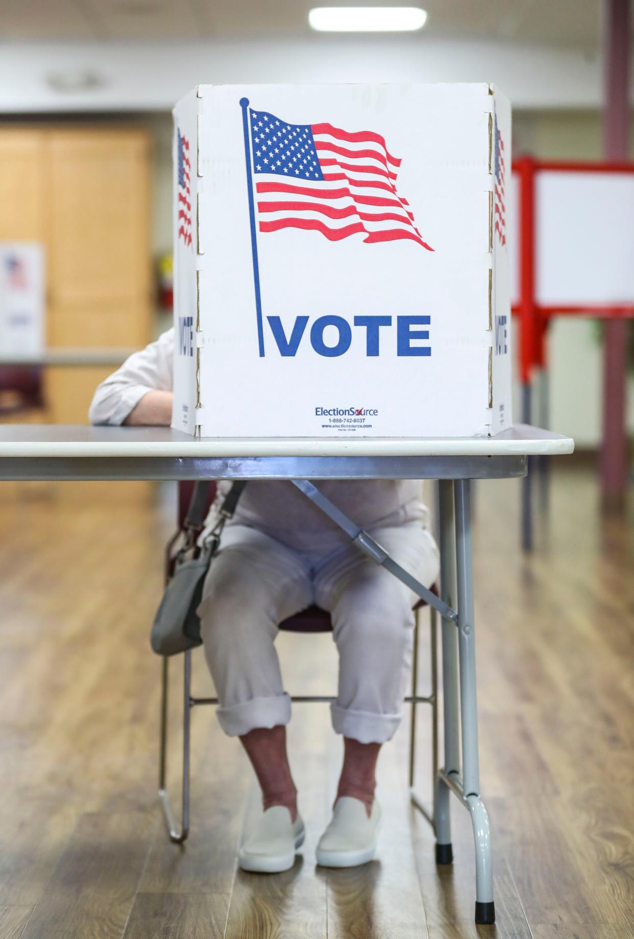 A woman casts her vote at the Immanuel Church of Christ in Louisville during the 2022 primary election. May 17, 2022