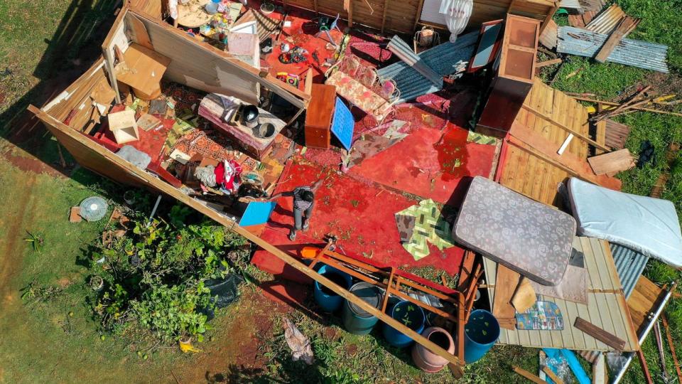 PHOTO: In an aerial view, Olive Rowe stands in what remains of her home after it was destroyed when Hurricane Beryl passed through the area on July 5, 2024, in Saint Elizabeth Parish, Jamaica.  (Joe Raedle/Getty Images)