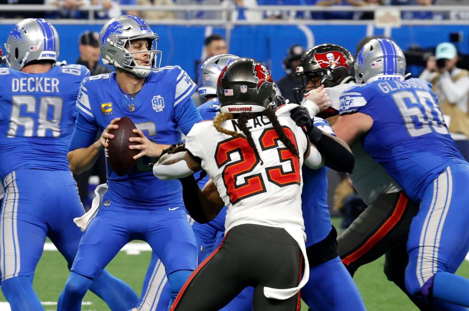 Detroit Lions quarterback Jared Goff looks for an open man as his offensive line protects him from the Tampa Bay defense during the first half against the Tampa Bay Buccaneers in the NFC Divisional Playoff at Ford Field in Detroit on Sunday, Jan. 21 2024.