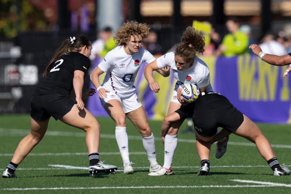 New Zealand’s Sylvia Brunt, right, tackles England’s Abby Dow, second right, as New Zealand’s Georgia Ponsonby and England’s Ellie Kildunne watch (AP)