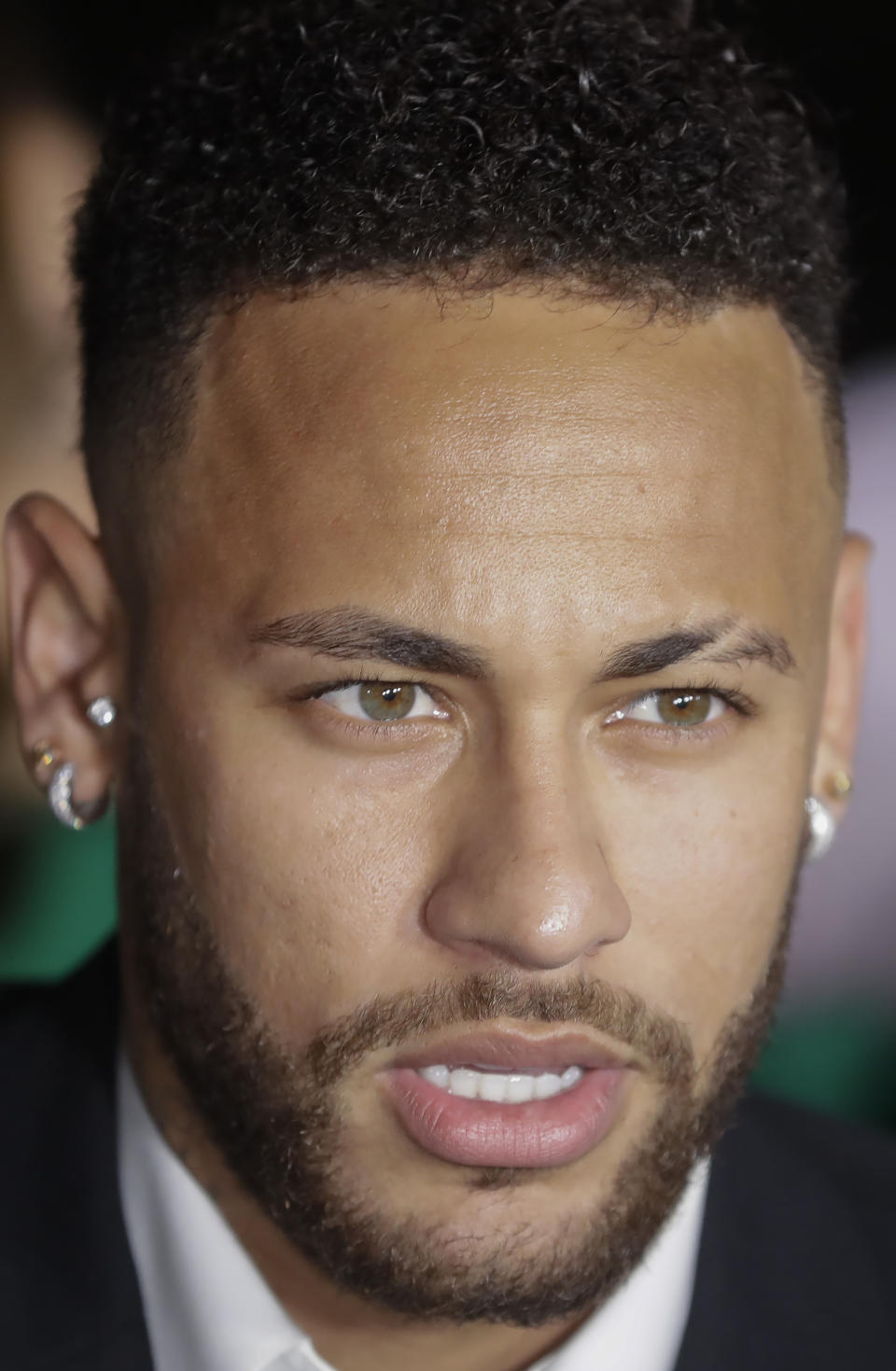 Brazil's soccer player Neymar speaks to the press as he leaves a police station where he answered questions about rape allegations against him in Sao Paulo, Brazil, Thursday, June 13, 2019. Neymar denies any wrongdoing. (AP Photo/Andre Penner)