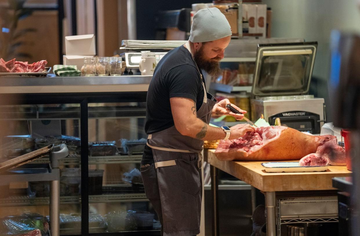 Alex Lyskowicz butchers pork Thursday at the new location of Bavette la Boucherie, 217 N. Broadway. As at the previous location, the butcher works in view of customers at the bar. The restaurant, which opens Friday for lunch and dinner, moved from a few blocks away in the Third Ward, 330 E. Menomonee St.