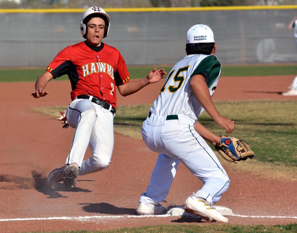 Centennial's Aaron Gutierrez (Red) tries to advance to third base as Mayfield's Julian Gallegos waits with the ball to apply the tag.