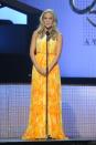 Carrie Underwood lit up the stage in this bright-yellow, belted Pamella Roland gown. (Photo by Rick Diamond/Getty Images)