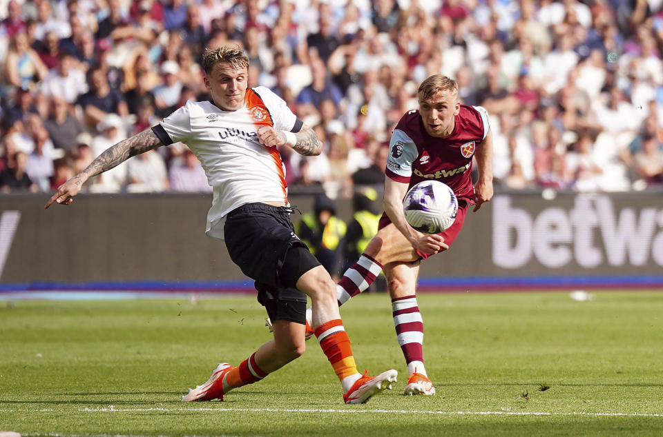 Luton Town's Alfie Doughty blocks a shot from West Ham United's Jarrod Bowen during the English Premier League soccer between West Ham United and Luton Town match at the London Stadium, London, Saturday May 11, 2024. (Victoria Jones/PA via AP)