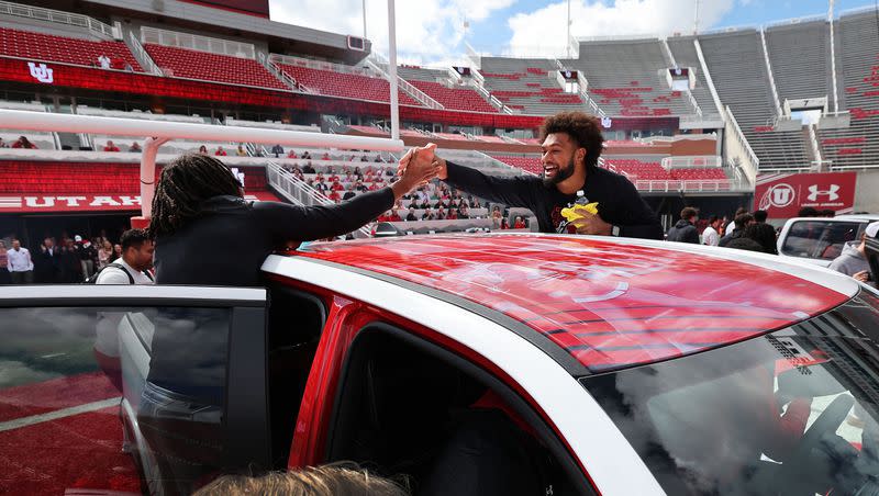 Utah Utes scholarship football players celebrate getting a Dodge truck given to them by the Crimson Collective during an NIL announcement at Rice-Eccles Stadium in Salt Lake City on Wednesday, Oct. 4, 2023. Should such NIL contracts with state schools be public record?