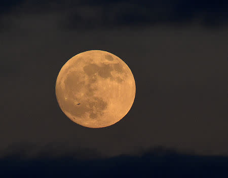 The first full moon of 2019 rises off the shore of Tenby, Pembrokeshire, Wales, Britain January 20, 2019. REUTERS/Rebecca Naden