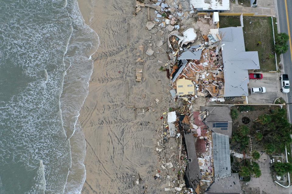 Homes partially toppled onto the Daytona Beach after Hurricane Nicole came ashore on November 10, 2022.