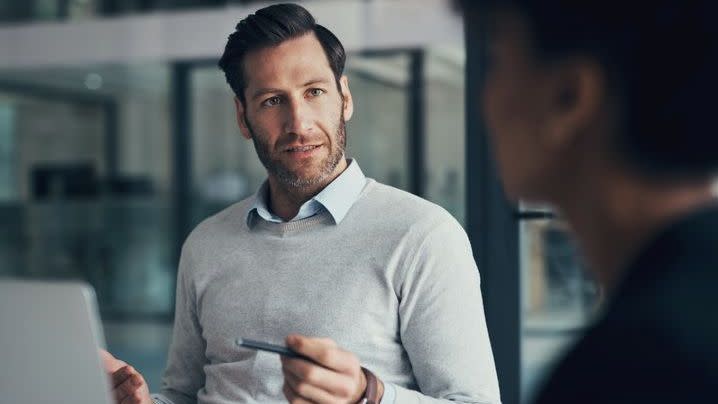 A financial advisor meets with a client in his office. 