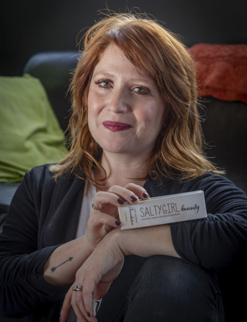 This undated photo provided by @saltygirlbeauty shows Sarah Kelly, a breast cancer survivor who, along with her sister Leah Robert, owns and operates SaltyGirl Beauty, an all-natural makeup brand inspired by Kelly's fight. (Heidi Kirn Photography/@saltygirlbeauty via AP)