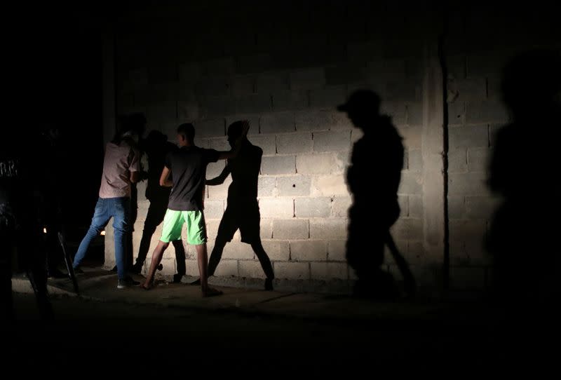 Members of the Special Action Force of the Venezuelan National Police (FAES) stop people during a night patrol, in Barquisimeto