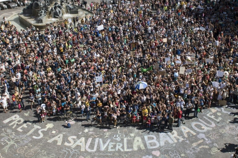 Marchers in the French city of Nantes stand in front of the words "Ready to save the house?" as part of a international day of climate protest on September 8, 2018