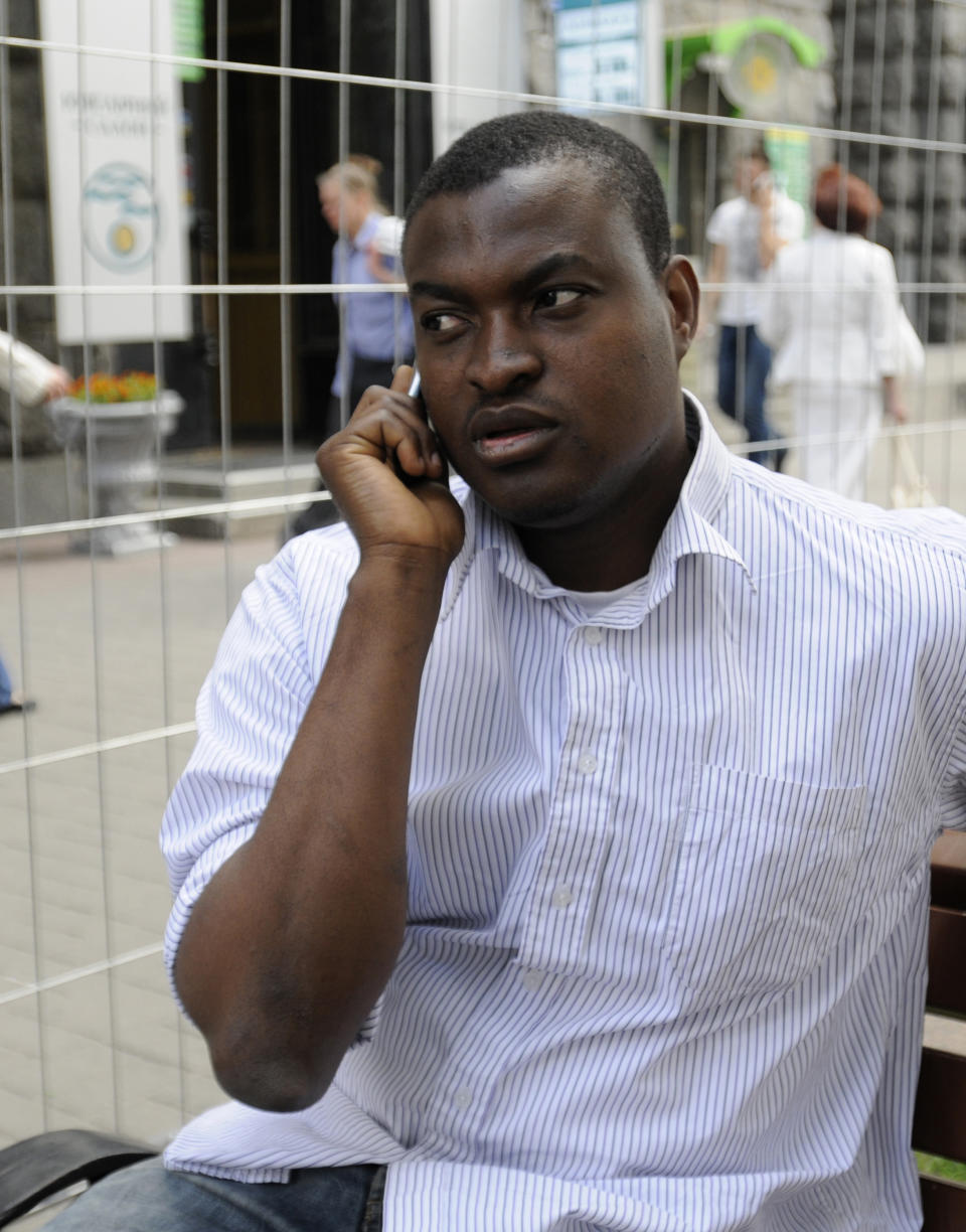 Victor Chikelu, a university student from Nigeria who was the victim of a racist attack, speaks on his cell phone in downtown Kiev, Ukraine, June 1, 2012. With a week to go until the Euro 2012 soccer tournament, Ukraine has been rocked by accusations of rampant racism after a British documentary showed thugs in one the Euro 2012 host cities violently beating dark-skinned soccer fans during a domestic league match. (AP Photo/Sergei Chuzavkov)