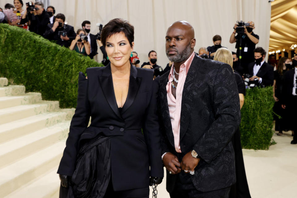 A close up of Kris Jenner and Corey Gamble as they pose on the Met Gala red carpet