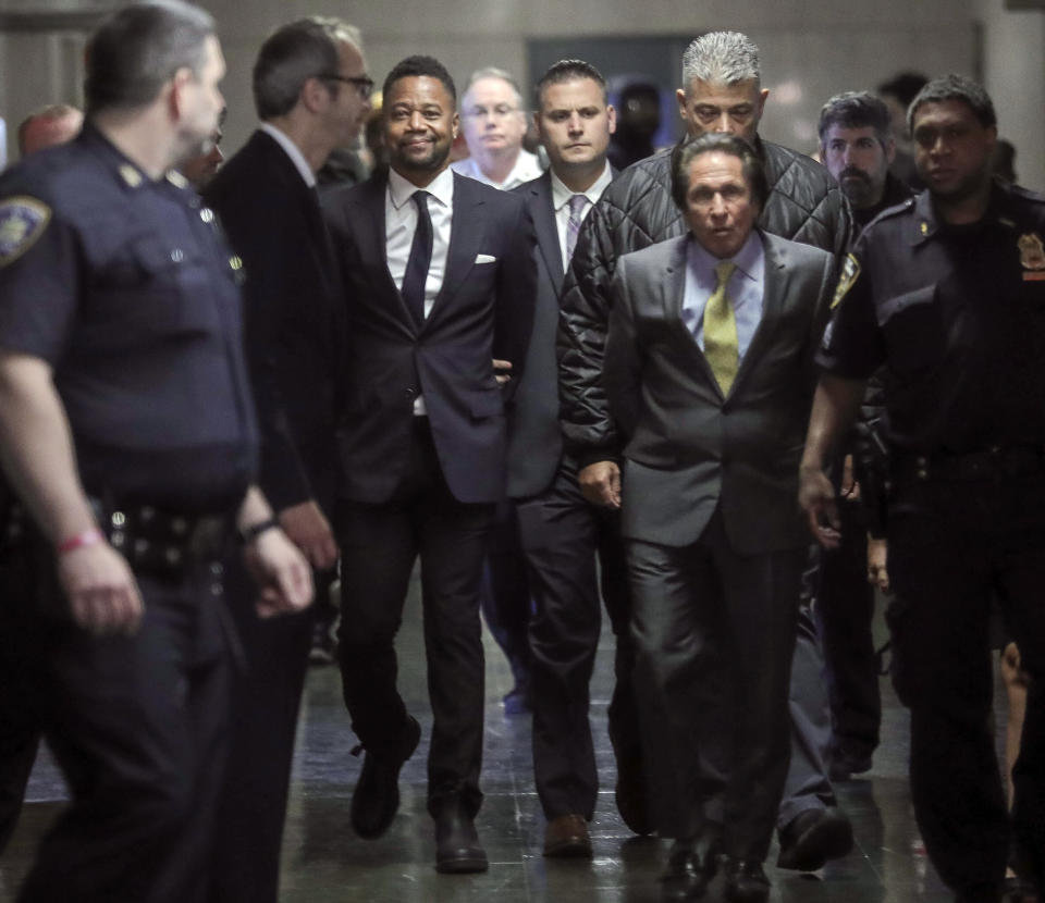 Cuba Gooding Jr., third from left, is escorted handcuffed as he arrives in court to face sexual misconduct charges, Tuesday Oct. 15, 2019, in New York. Gooding Jr. pleaded not guilty to an indictment alleging two instances of sexual misconduct. The new charge involves an alleged incident in October 2018. The defense paints it as a shakedown attempt. (AP Photo/Bebeto Matthews)