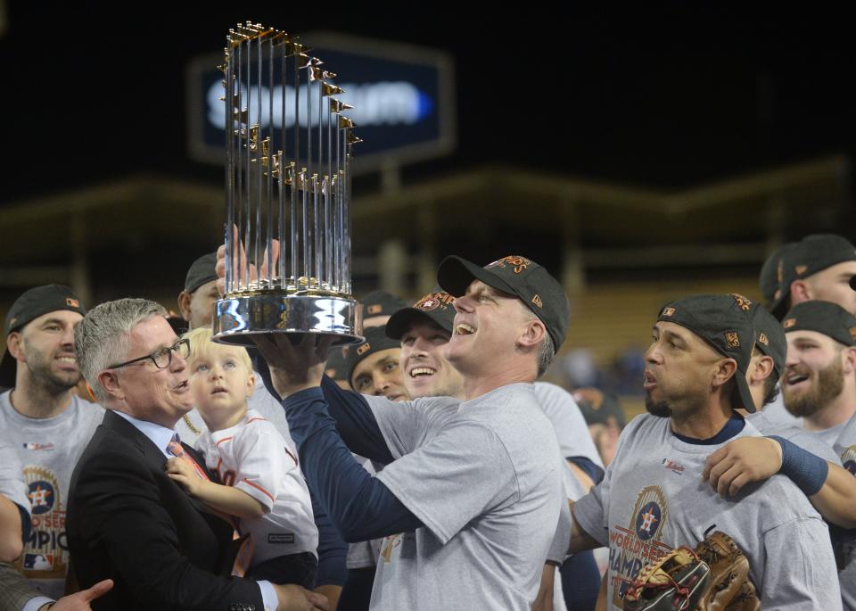 Houston Astros manager A.J. Hinch is presented with the Commissioner's Trophy after defeating the Los Angeles Dodgers in Game 7 of the World Series at Dodger Stadium, Nov. 1, 2017.