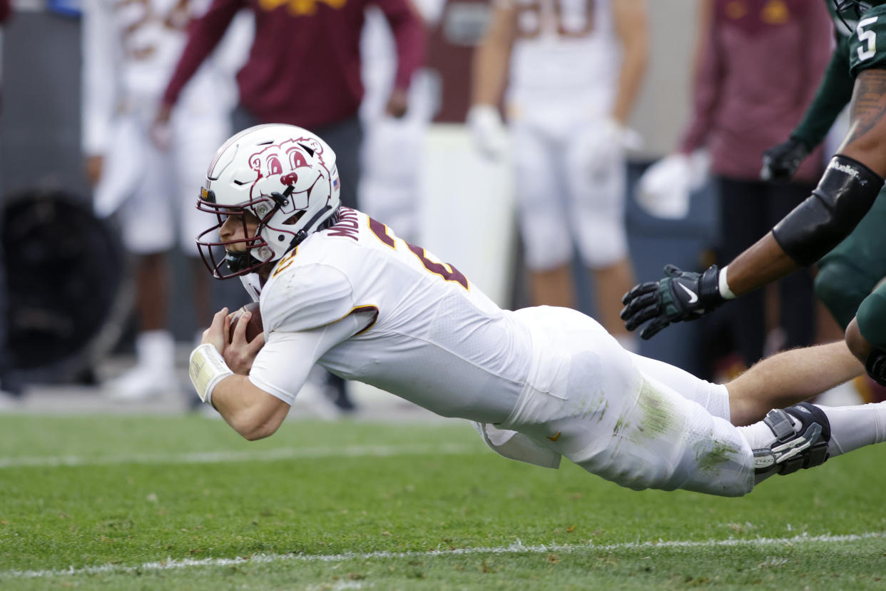 Minnesota quarterback Tanner Morgan dives for a first down against Michigan State during the second quarter of an NCAA college football game, Saturday, Sept. 24, 2022, in East Lansing, Mich. (AP Photo/Al Goldis)