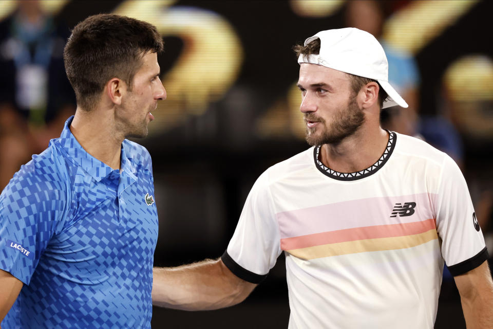 Novak Djokovic, left, of Serbia is congratulated by Tommy Paul of the U.S. after their semifinal at the Australian Open tennis championship in Melbourne, Australia, Friday, Jan. 27, 2023.(AP Photo/Asanka Brendon Ratnayake)