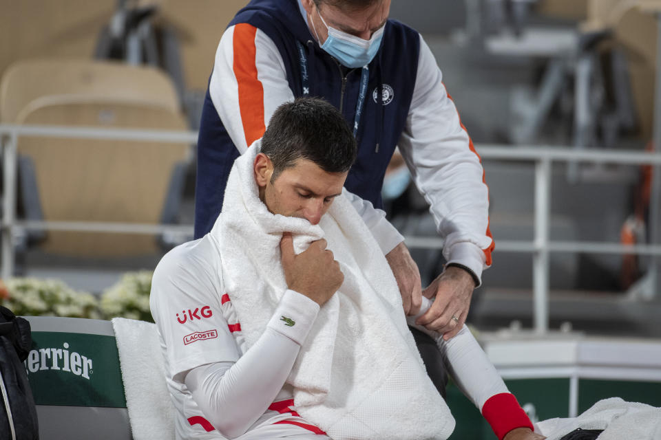 PARIS, FRANCE October 07.  Novak Djokovic of Serbia receiving treatment on his elbow during his match against Pablo Carreno Busta of Spain in the Quarter Finals of the singles competition on Court Philippe-Chatrier during the French Open Tennis Tournament at Roland Garros on October 7th 2020 in Paris, France. (Photo by Tim Clayton/Corbis via Getty Images)