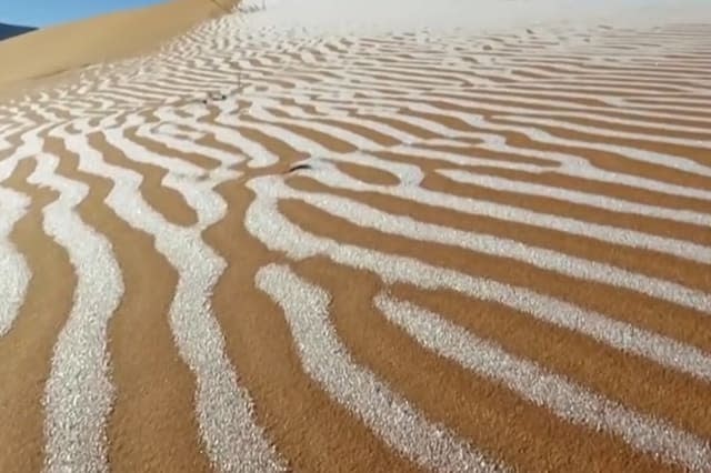 Snow blankets sand in the Sahara desert