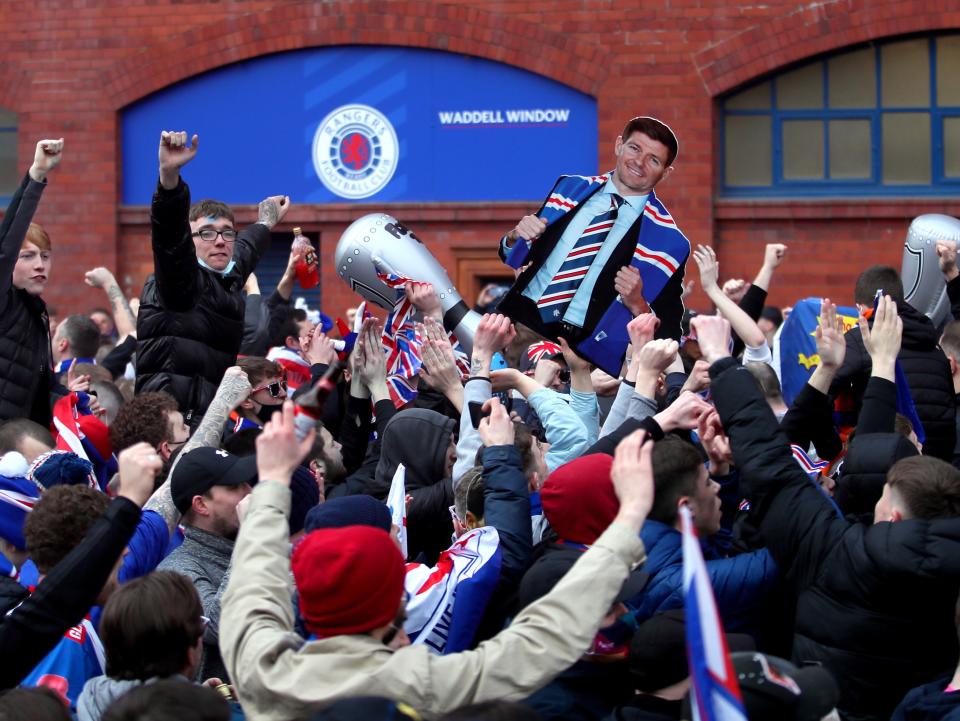 Rangers fans celebrate winning the Scottish title in March (PA)