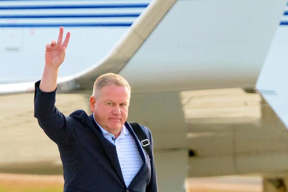New LSU football coach Brian Kelly gestures to fans after his arrival at Baton Rouge (La.) Metropolitan Airport last week. Kelly reportedly agreed to a 10-year contract with LSU worth $95 million plus incentives.