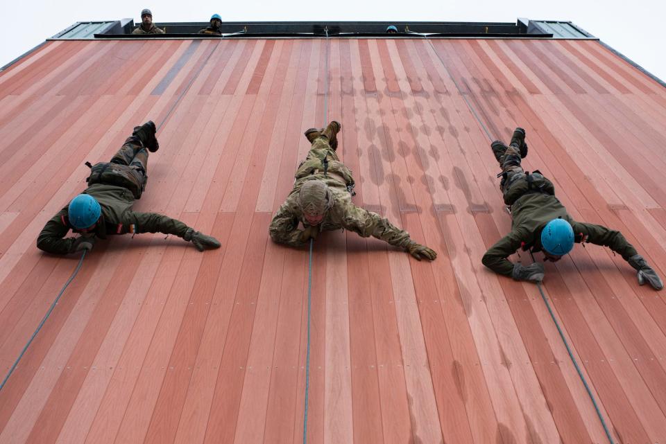 US and Indian soldiers rappel down wall