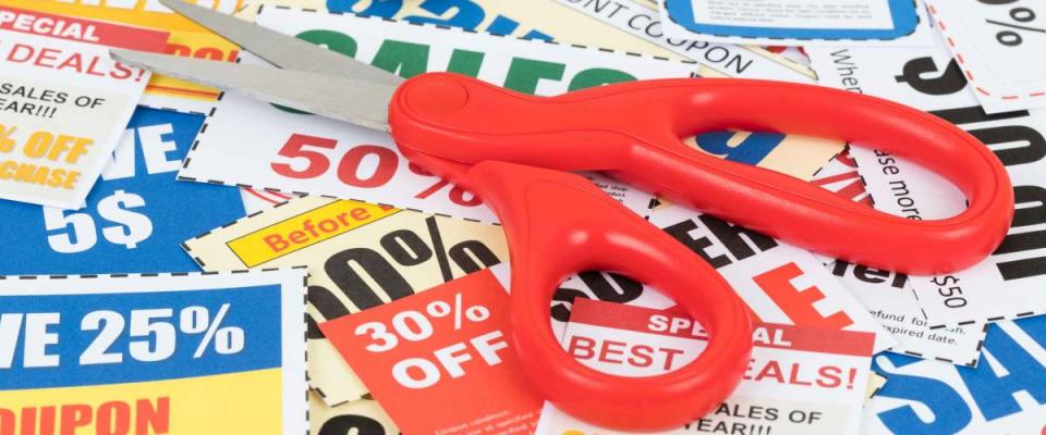 Saving discount coupon voucher with scissor, coupons are mock-up