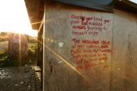 Verses of "The New Colossus" sonnet by Emma Lazarus are written on a wooden structure at the demolished "Jungle" migrant camp in Calais in northern France