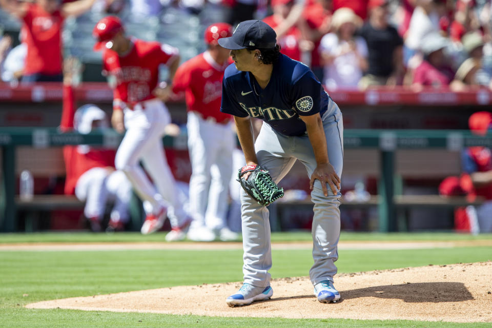 Seattle Mariners starting pitcher Marco Gonzales, foregound, reacts as Los Angeles Angels' Livan Soto, back left, rounds third on a two-run home run by Luis Rengifo during the third inning of a baseball game in Anaheim, Calif., Sunday, Sept. 18, 2022. (AP Photo/Alex Gallardo)