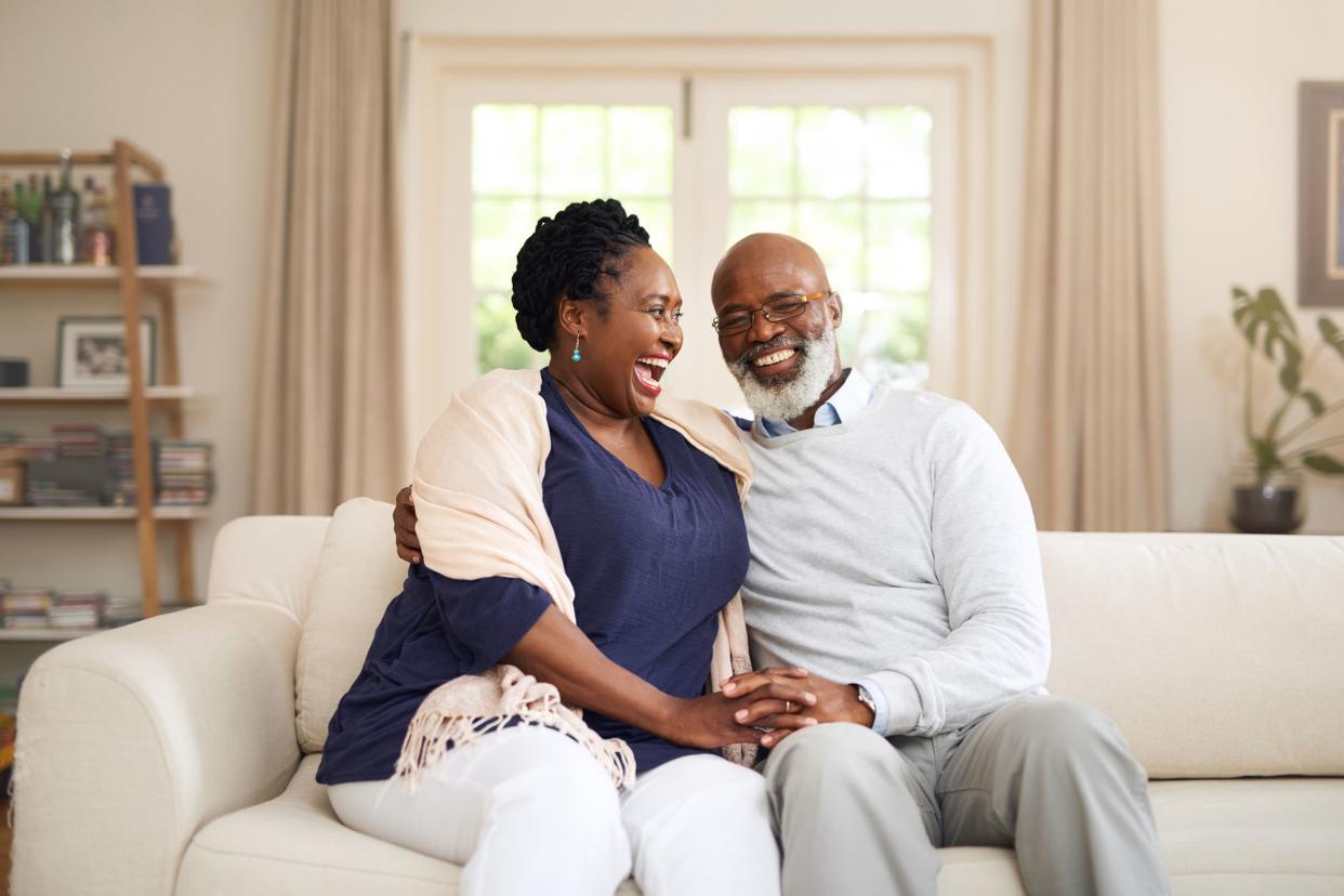 happy middle-aged couple on couch in living room