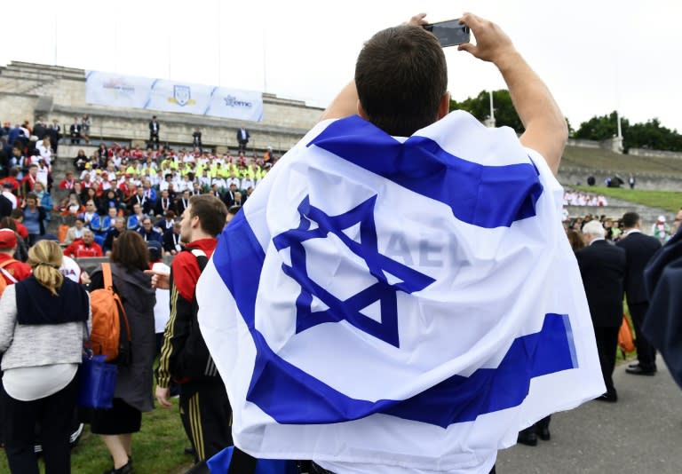 A member of the Israeli Team takes a picture at the so-called "Maifeld", near the Olympic Stadium of Berlin, before the official opening ceremony of the 14th European Maccabi Games in Berlin, on July 28, 2015