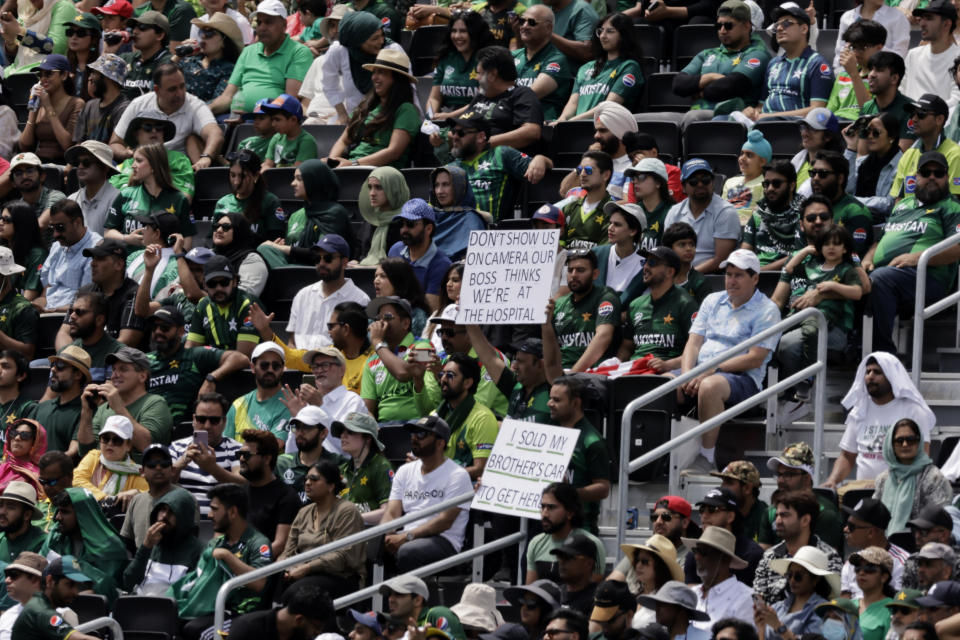 Pakistan supporters display placards as they watch the ICC Men's T20 World Cup cricket match between Pakistan and Canada at the Nassau County International Cricket Stadium in Westbury, New York, Tuesday, June 11, 2024. (AP Photo/Adam Hunger)