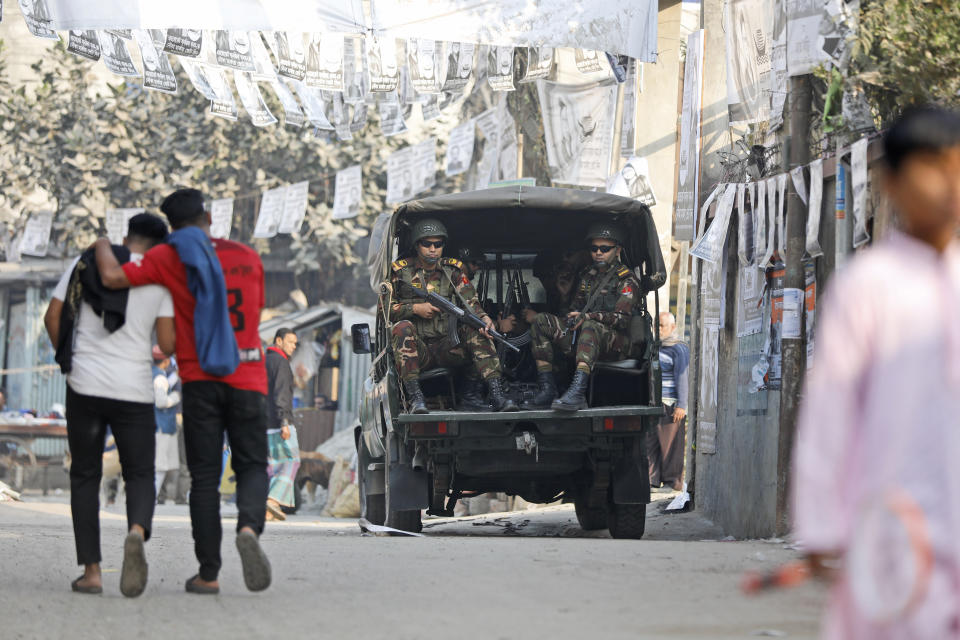 Bangladesh Army soldiers keep guard outside a polling booth in Dholaipar area in Dhaka, Bangladesh, Friday, Jan. 5, 2024. Bangladesh’s main opposition party called for general strikes on the weekend of the country's parliamentary election, urging voters to join its boycott. This year, ballot stations are opening amid an increasingly polarized political culture led by two powerful women; current Prime Minister Sheikh Hasina and opposition leader and former premier Khaleda Zia. (AP Photo/Mahmud Hossain Opu)