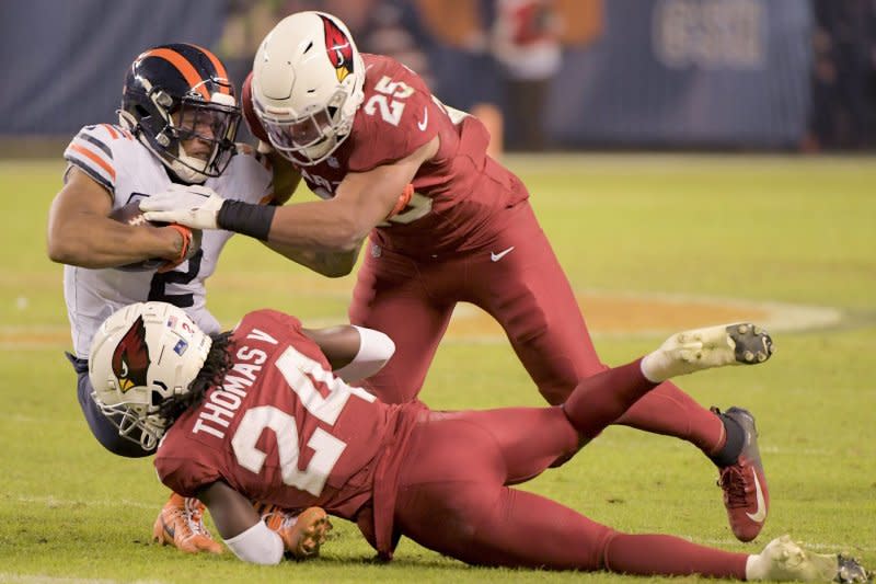 Chicago Bears wide receiver D.J. Moore (L) is taken down by Arizona Cardinals defenders Starling Thomas V (C) and Zaven Collins after making catch Sunday at Soldier Field in Chicago. Photo by Mark Black/UPI