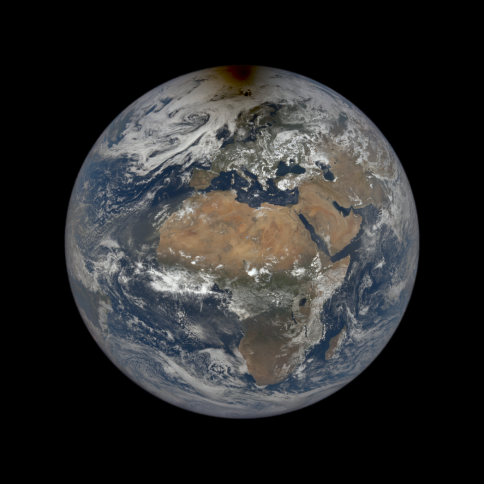 An image of the Earth with a dollop of shadow over its arctic generated by the Moon moving between our planet and the Sun.