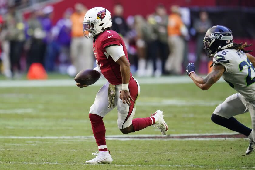 Cardinals quarterback Kyler Murray runs with the ball against Seahawks safety Ryan Neal on Nov. 6, 2022, in Glendale, Ariz.