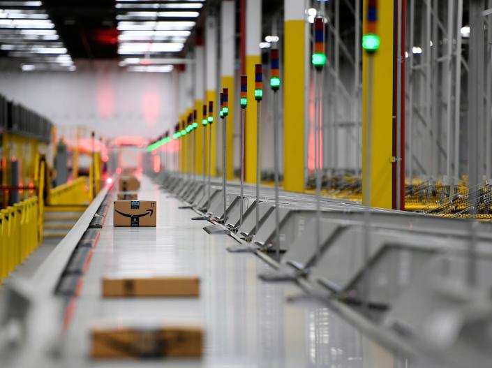 Amazon box on conveyor belt in Amazon fulfillment center warehouse