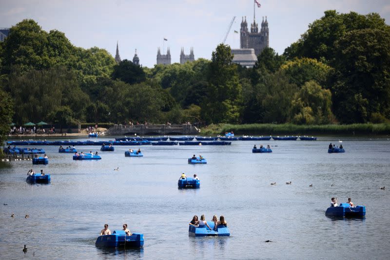FILE PHOTO: People ride pedal boats on the Serpentine Lake in Hyde Park, during warm weather in London