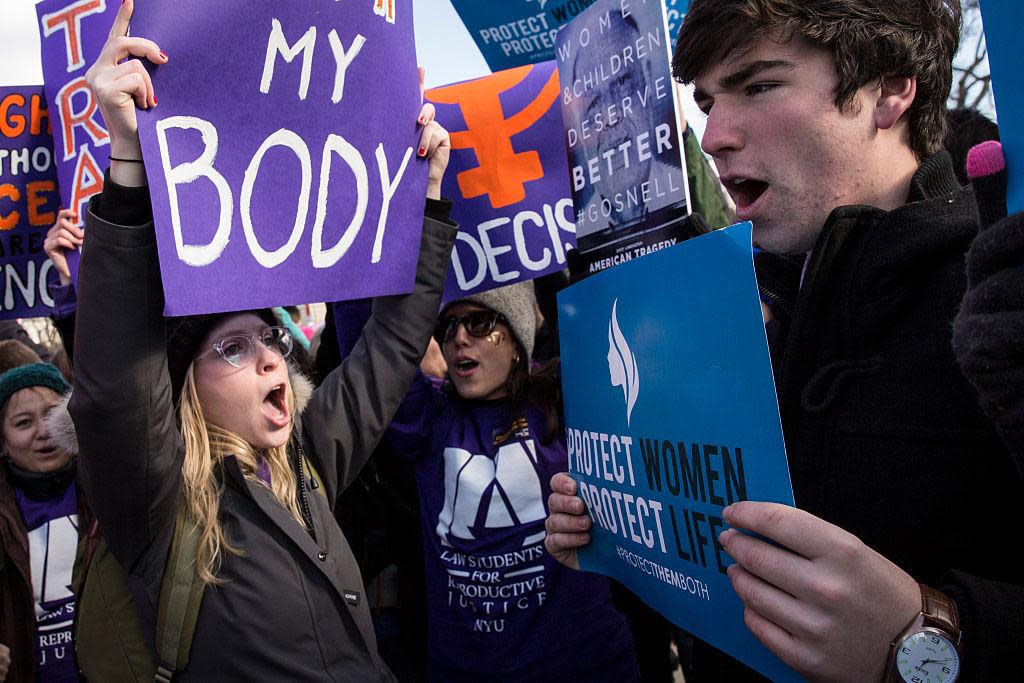 Pro-choice advocates (left) and anti-abortion advocates (right) rally outside of the Supreme Court, March 2, 2016 in Washington, DC: Drew Angerer/Getty